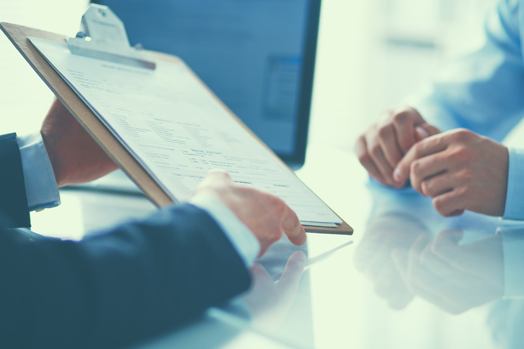 Businesspeople sitting on the desk in office